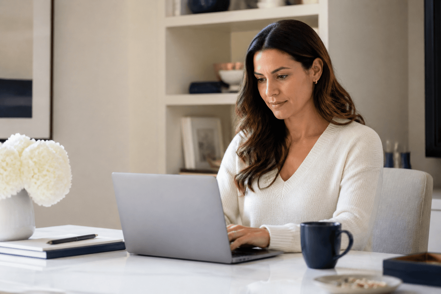 Adult completing a health assessment on a laptop at home